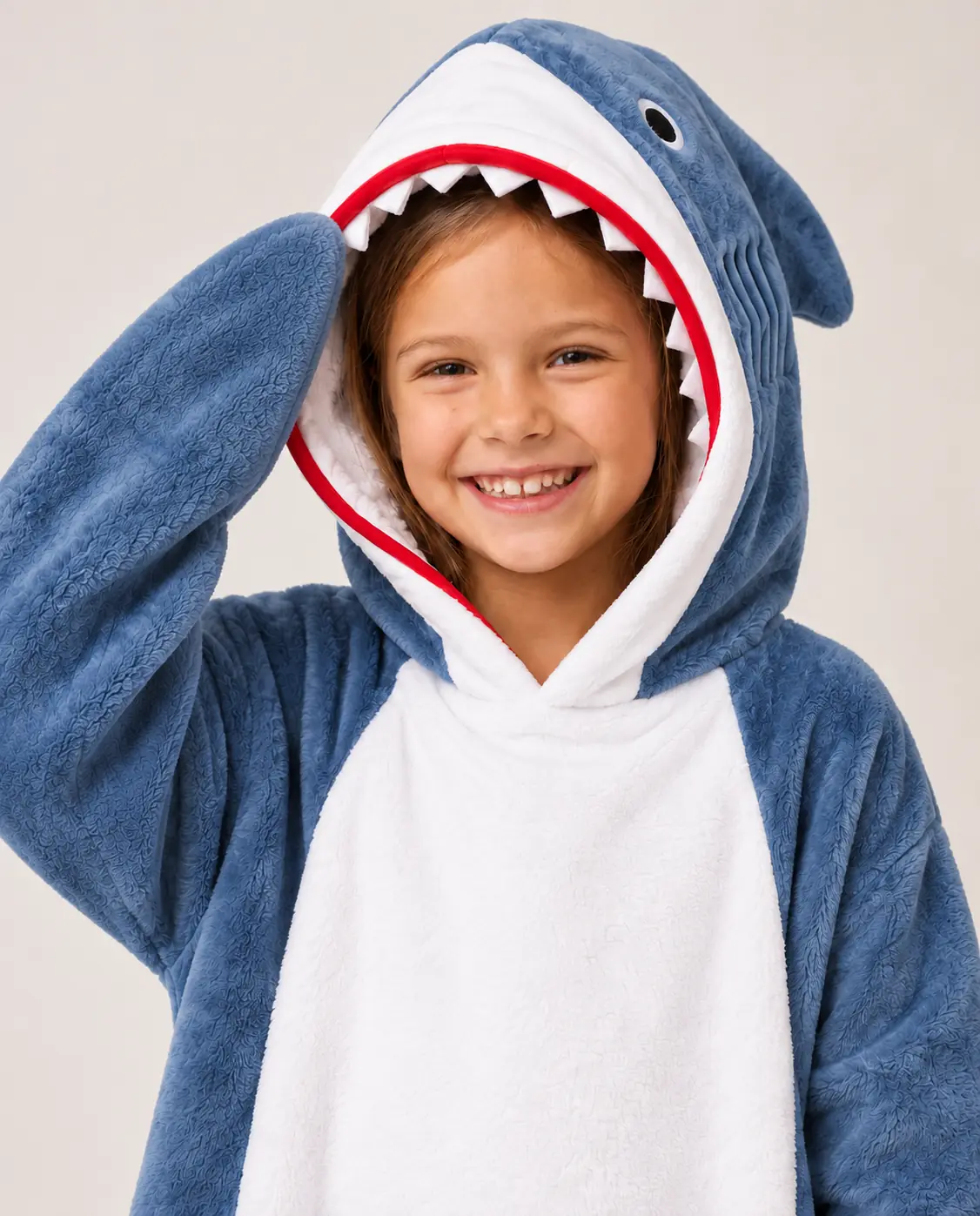 Close-up of a smiling girl with the shark hood with teeth of the Shark Kids Moffli