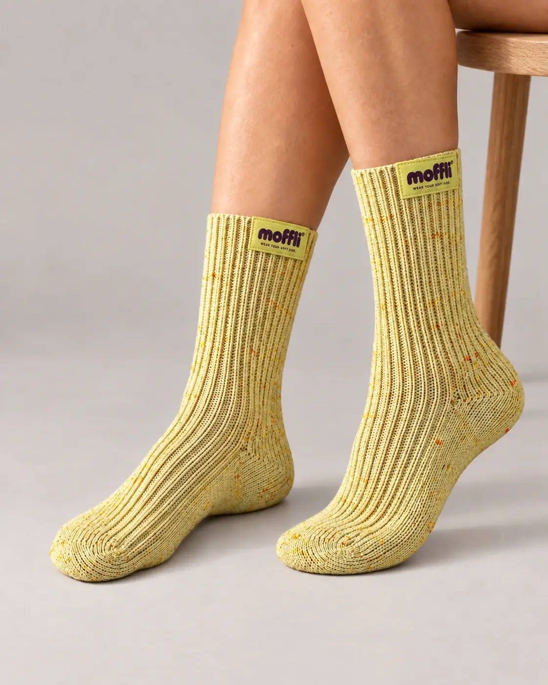 MOFFLI Cosy Socks Butter Yellow next to stool