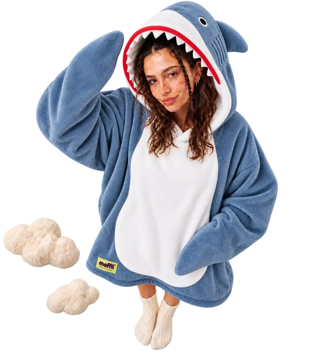 Model seen from above wearing the blue and white Shark Moffli, hand lifting the shark mouth hood, other hand in the pocket, Moffli label and two soft clouds
