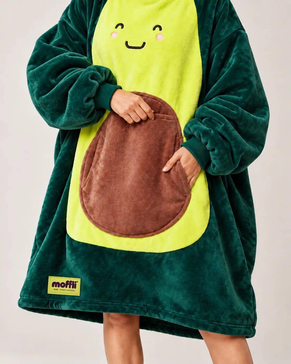 Detail of the Avocado Moffli front with smiling face, pit pocket and Moffli label