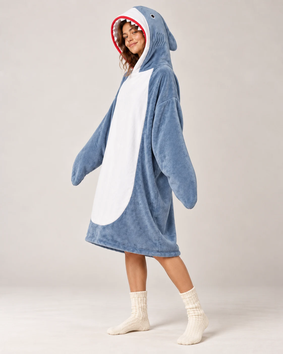 Woman full length wearing the Shark Moffli, three-quarter view with fin on the hood