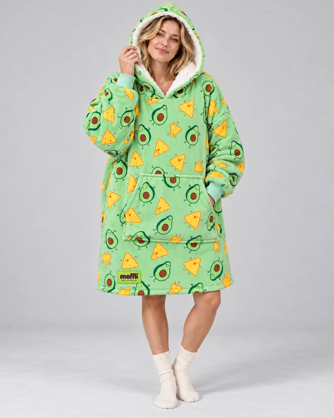 Woman sitting on the sofa wrapped in the Avocado & Nachos Moffli, with bare legs