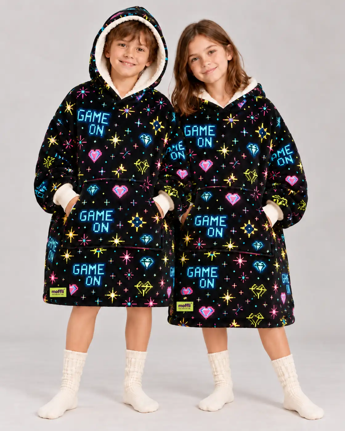 Boy and girl standing wearing the Game On Moffli, hands in front pocket