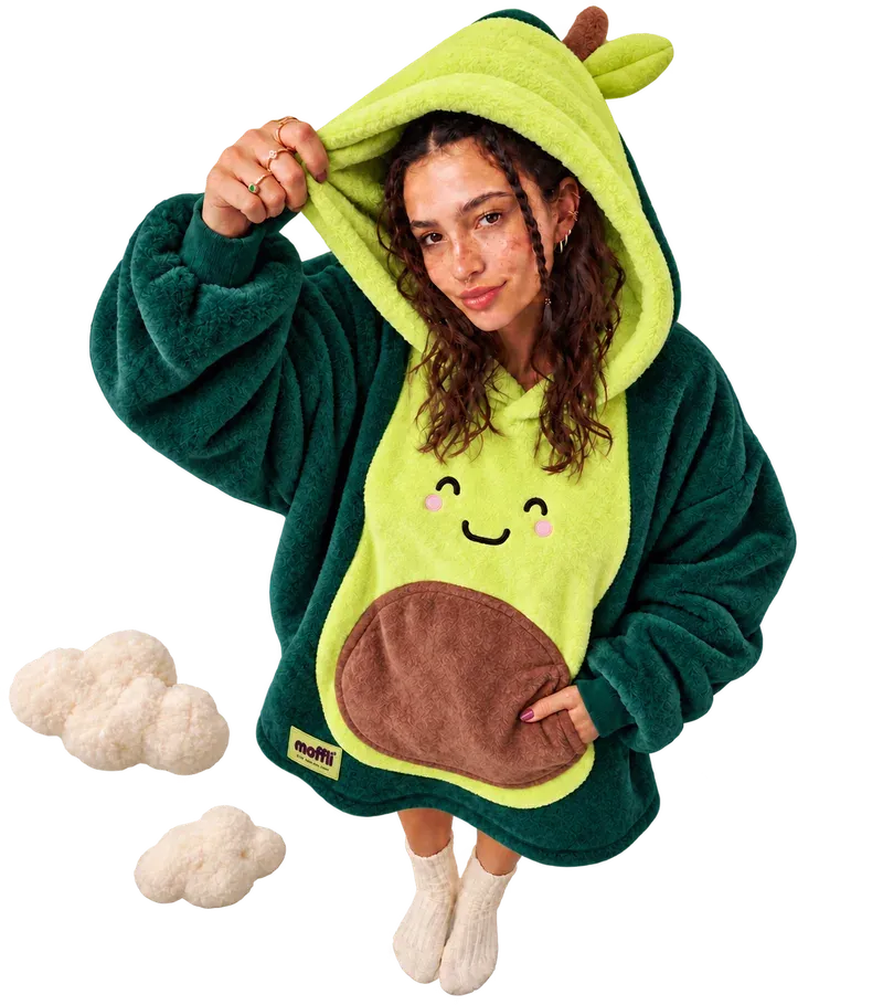 Model seen from above wearing the Avocado Moffli, hand lifting the leafy hood, other hand in the pit pocket and two soft clouds