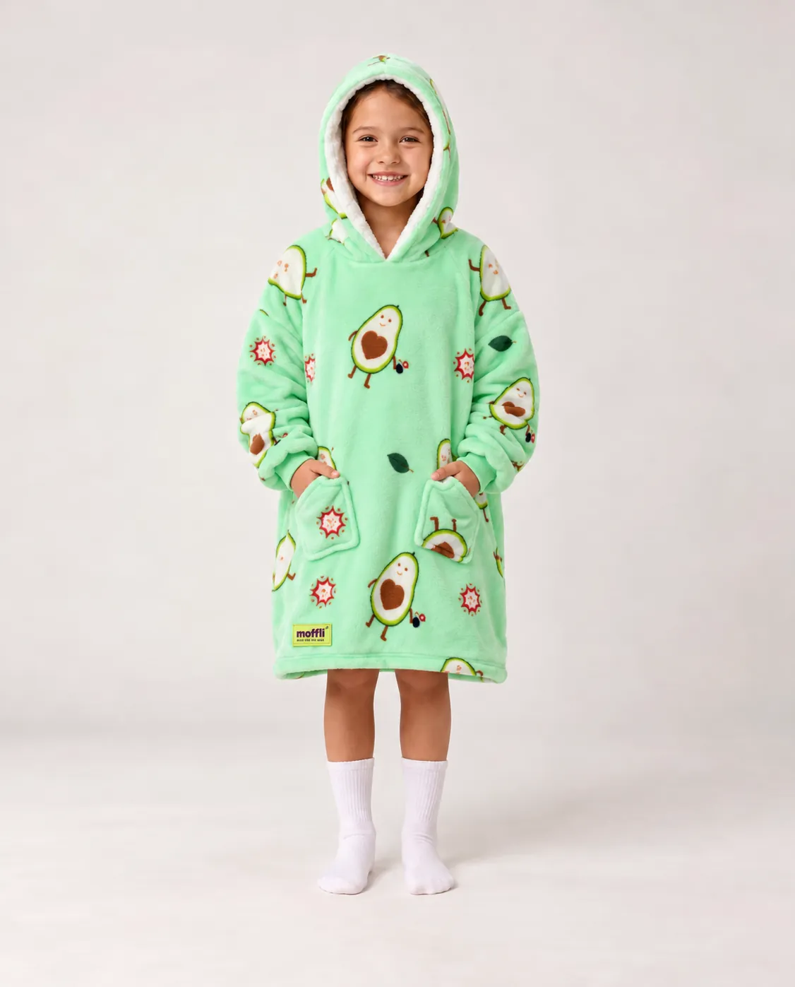 Girl standing wearing the mint green Avocado Love Kids Moffli, hood up and hands in pockets