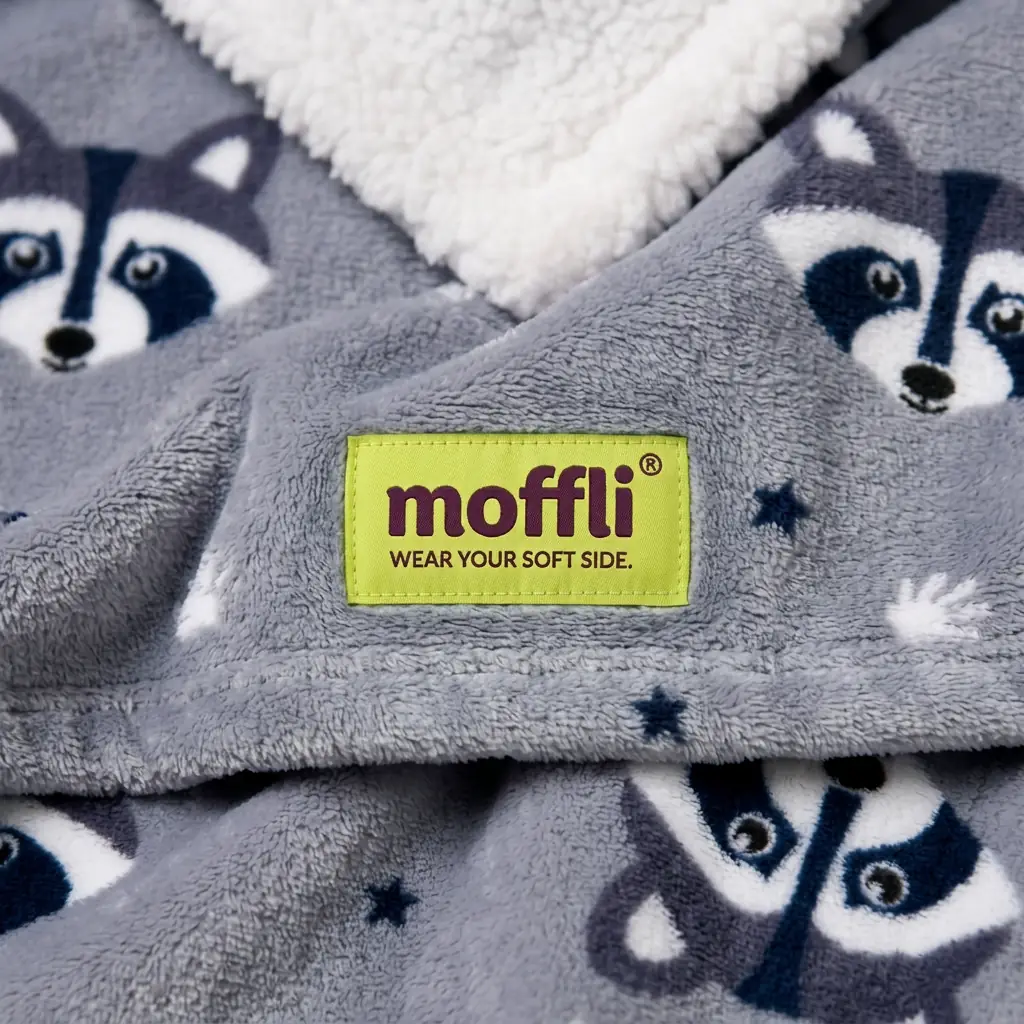 Detail of the grey fabric of the Raccoon Kids Moffli with raccoon print, Moffli label and sherpa lining