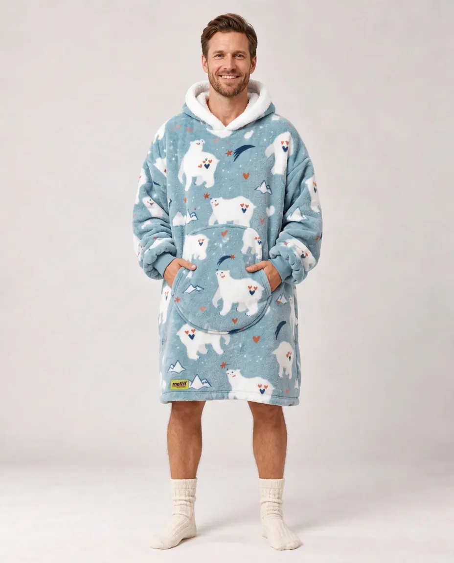 Smiling man full length wearing the blue Polar Bear Moffli and hands in pocket